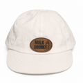 Milk Drunk white baby hat with brown leather patch